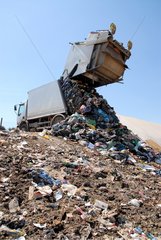 Garbage truck unloading in a dump