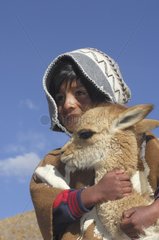 Children Quechua and young vicuña Altiplano Bolivia