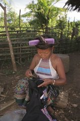Kui woman mending of traditional clothing Laos
