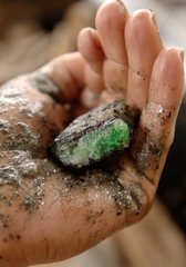 Crude emerald in a hand Minas Gerais Brazil