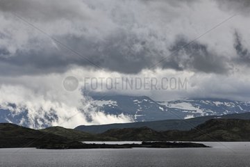Djup Lake and Mountains in clouds Norway