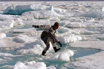 Man jumping on a stable plate of Arctic sea ice