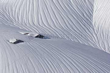 Chalets while climbing at the pass of Cou  above Champery  covered with snow  Valais  Alps  Switzerland