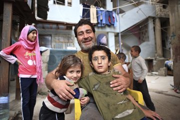 Palestinian man and his children in the Sabra camp in Lebanon