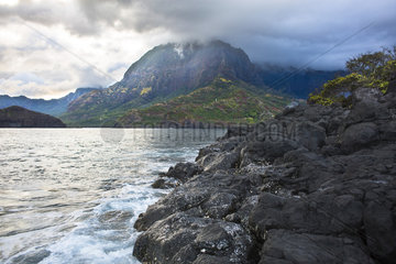 Temetiu summit in the clouds and Atuona Bay as seen from Teaeoa Point  Hiva Oa  Marquesas Islands  French Polynesia