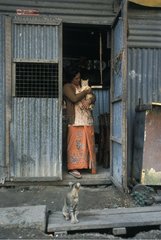 Woman wearing a cat at the entrance to a habitat Burma