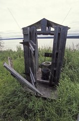 WC of Hunt hut on Mackenzie riverbank Canada