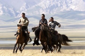 Nomadic horsemen playing in a meadow in Kyrgyzstan