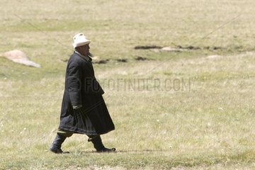 Nomad walking in a meadow in Kyrgyzstan