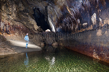 Speleologist in front of a beautiful fault mirror in a cave. UNESCO label Geoparc   Bauges Regional Nature Park  Savoie  Alps  France