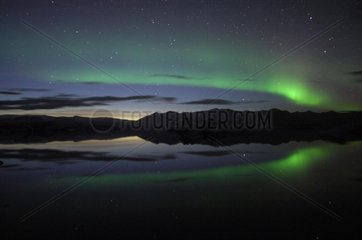 Aurora borealis reflecting on lake Joekulsárlón Iceland