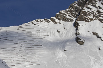 Installed after the avalanche of 1984 over the Diablerets  the 4-meter-high avalanches are  in some places  full of snow and fulfill their role. Mountain La Pare. Vaud  Alps  Switzerland