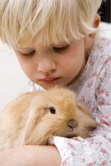 Child with small rabbit ram France