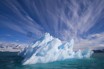 Small iceberg drifting in fiord in summer Svalbard