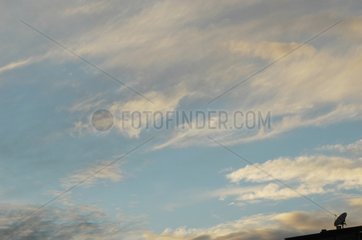 Antenne satellite sur un toit sur fond de ciel nuageux