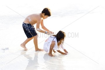 Indian children playing on the beach Caribbean Sea Mexico