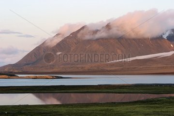 Mountains in clouds and cold sea Spitsbergen Arctic