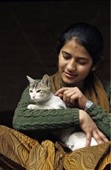 Young woman holding a cat in her arms Nepal