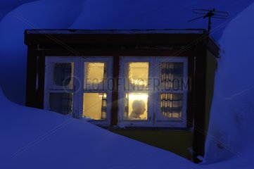 Man in his home during the polar night Greenland