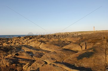 Rocks on the Manche coast and lighthouse of Gatteville
