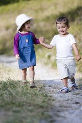 Girl and boy walking hand in hand Southern Alps