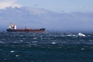 Cargo liner at anchor in the stormy Magellan Strait