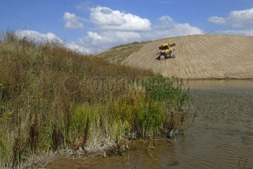 Bulldozer leveling a mine dump in a former potash mine