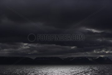 Fjord Isafjardjup under a threatening sky in spring Iceland