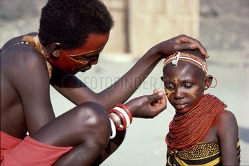 El Molo Warriors painting his wife's face Lake Turkana