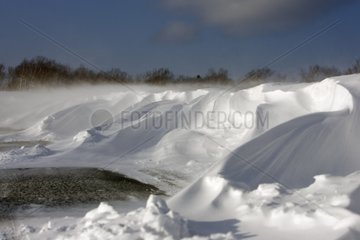 Snow drifted by the wind onto a road Hokkaido Japan