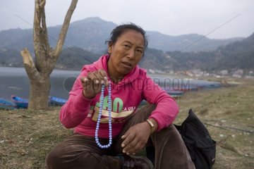 Tibetan woman with a necklace for sale Nepal