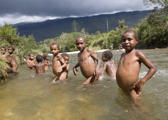Children bathing in the river Sepik Papua New Guinea