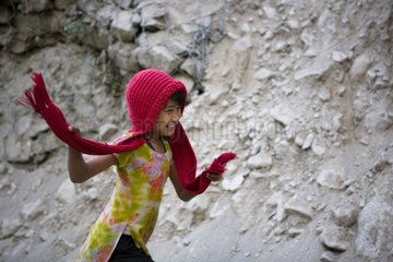 Girl running by taking his scarf Annapurna Nepal