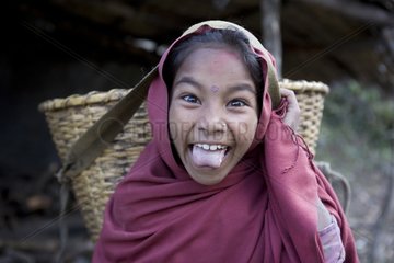 Girl carrying a load and its tongue Annapurna Nepal