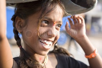 Portrait of Girl carrying a load on his head India
