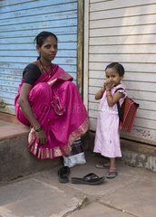 Woman and girl going to school Ratnagiri India
