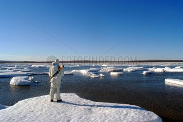 Man looking at the ice in the Bay of Goodsir Inlet
