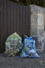 Selecting waste bags in front of a portale