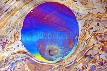 Polarization and diffraction in a puddle of oily water