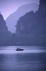 Rowing boat in Ha Long bay Vietnam