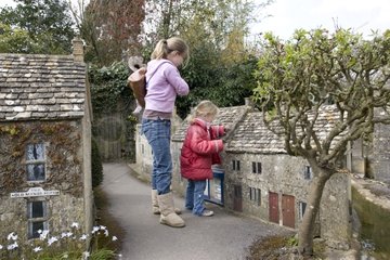 Children admiring miniature Cotswold houses model village
