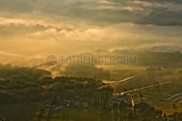 Mists of Savoyard countryside at dawn - France