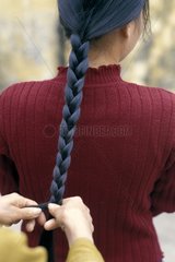 Girl braiding her hair Vietnam