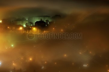 City of Annecy in the fog at night in winter