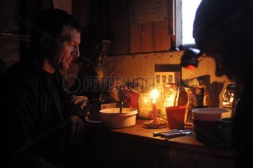 Evening with the candle in the hut of Worsley Spitzberg