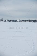 Village of Stari under snow at the edge of the lake Ladoga Russia