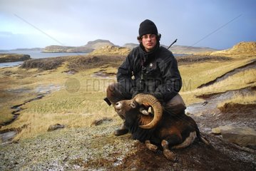 Hunter posing with a dead sheep Kerguelen island