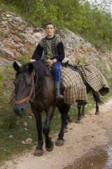 Young peasant riding a horse in Carpates Romania