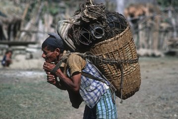 Local trader carrying basket of salt Karnali Western Nepal