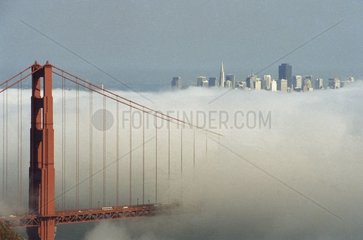 Golden Gate and buldings of City in the morning fog USA